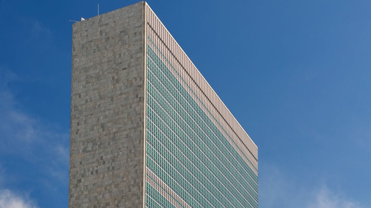 The iconic United Nations building in NYC captured against a vibrant blue sky, showcasing its modern architecture.